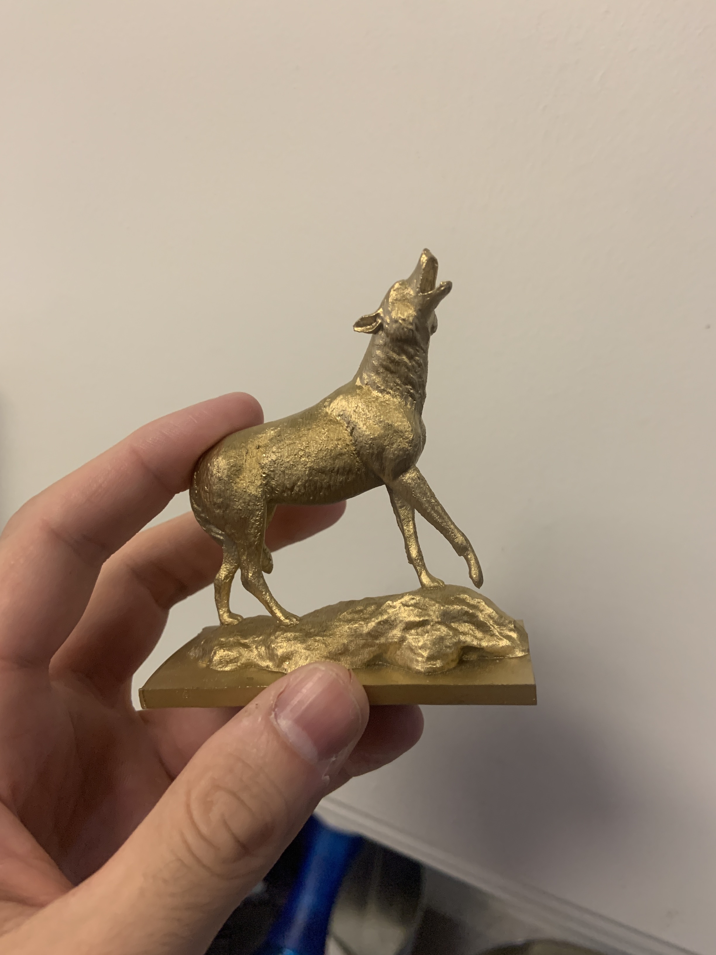 A resin print of the CSUSB coyote statue, spray painted gold